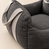 Close view of the woven fabric, stitching and carrying strap