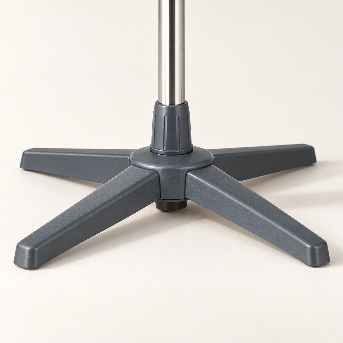 Close-up of the grey four-foot base and central support